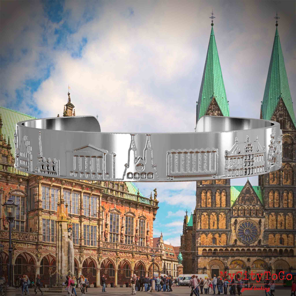 Versilberter Armreif mit Reliefs bekannter Sehenswürdigkeiten der Stadt Bremen. Den Hintergrund bildet eine Ansicht der Stadt Bremen.