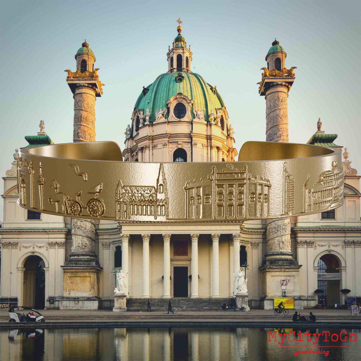 Armreif aus vergoldetem Edelstahl mit Reliefs bekannter Sehenswürdigkeiten der Stadt Wien. Den Hintergrund bildet eine Ansicht der Stadt Wien.