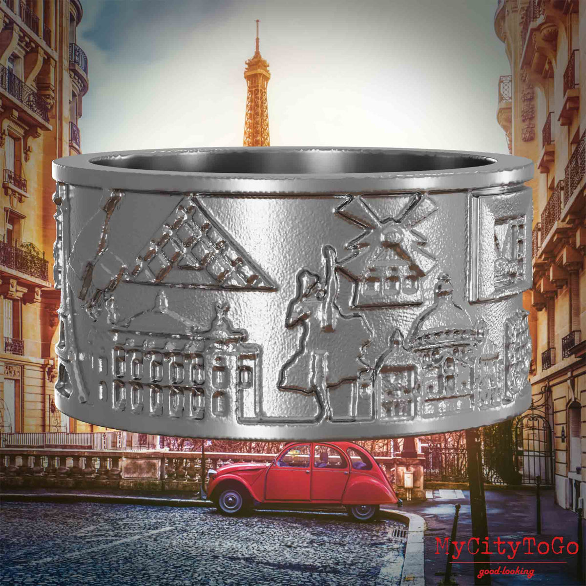 Ring aus Edelstahl mit Reliefs bekannter Sehenswürdigkeiten der Stadt Paris. Den Hintergrund bildet eine Ansicht der Stadt Paris.