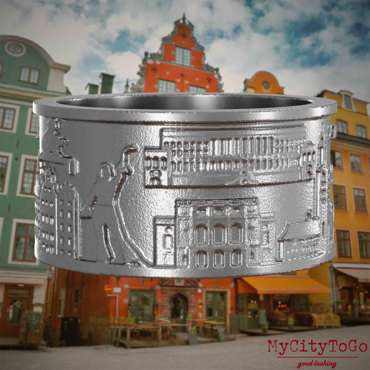 Ring aus Edelstahl mit Reliefs bekannter Sehenswürdigkeiten der Stadt Stockholm. Den Hintergrund bildet eine Ansicht der Stadt Stockholm.