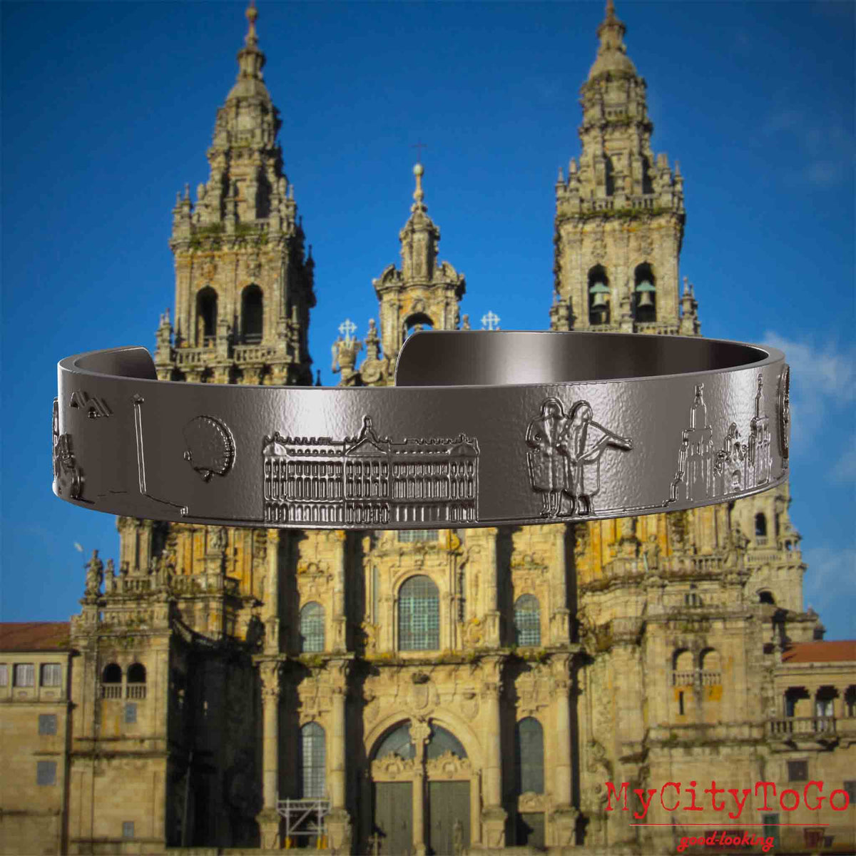 Armreif aus Titan mit Reliefs bekannter Sehenswürdigkeiten und Elemente des Jakobsweges. Den Hintergrund bildet die Kathedrale von Santiago de Compostela.