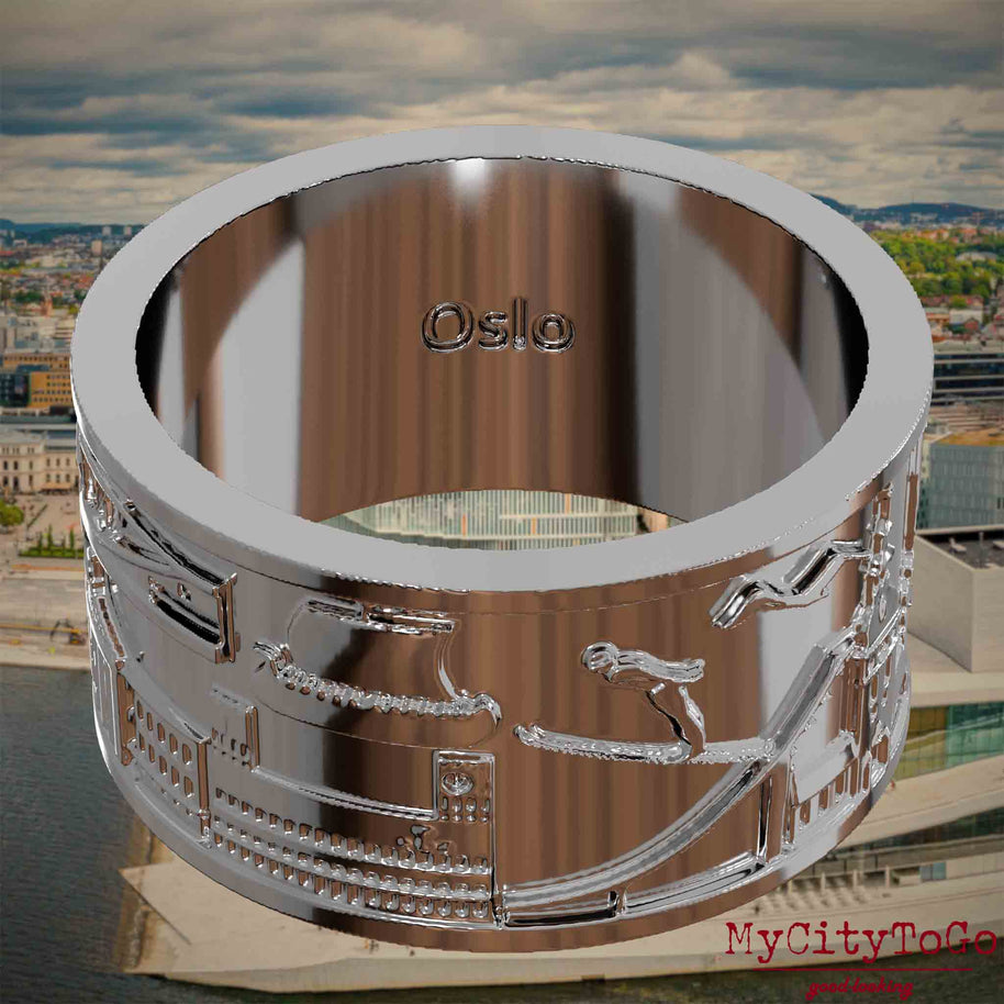 Versilberter Ring mit Reliefs bekannter Sehenswürdigkeiten der Stadt Oslo und einer Gravur des Stadtnamens auf der Innenseite. Den Hintergrund bildet eine Ansicht der Stadt Oslo.