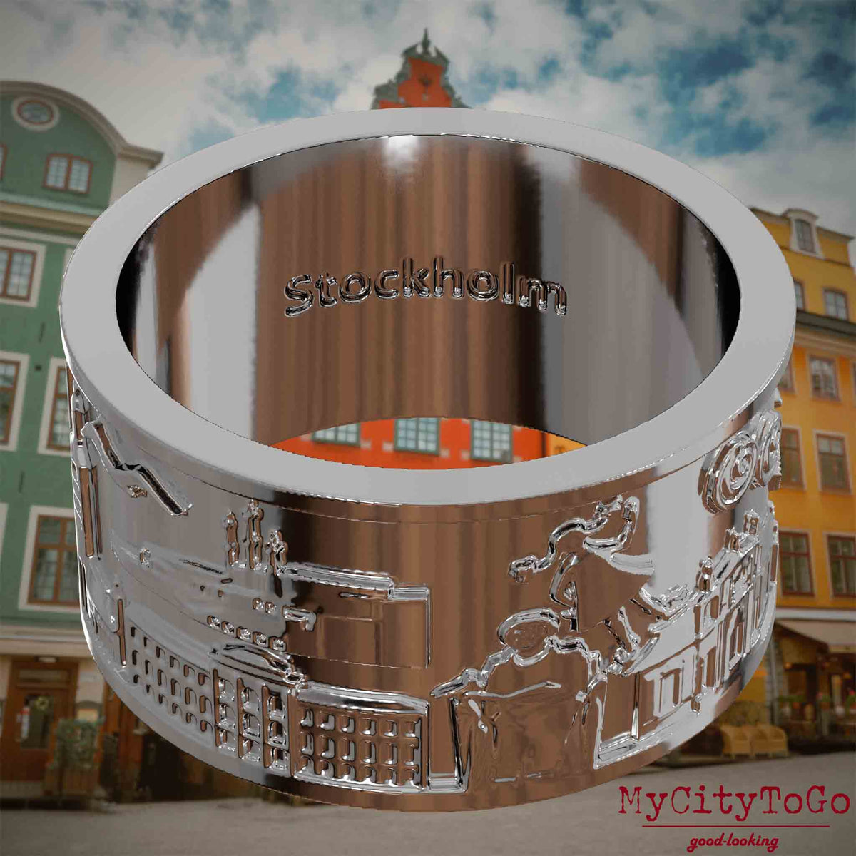 Versilberter Ring mit Reliefs bekannter Sehenswürdigkeiten der Stadt Stockholm und einer Gravur des Stadtnamens auf der Innenseite. Den Hintergrund bildet eine Ansicht der Stadt Stockholm.