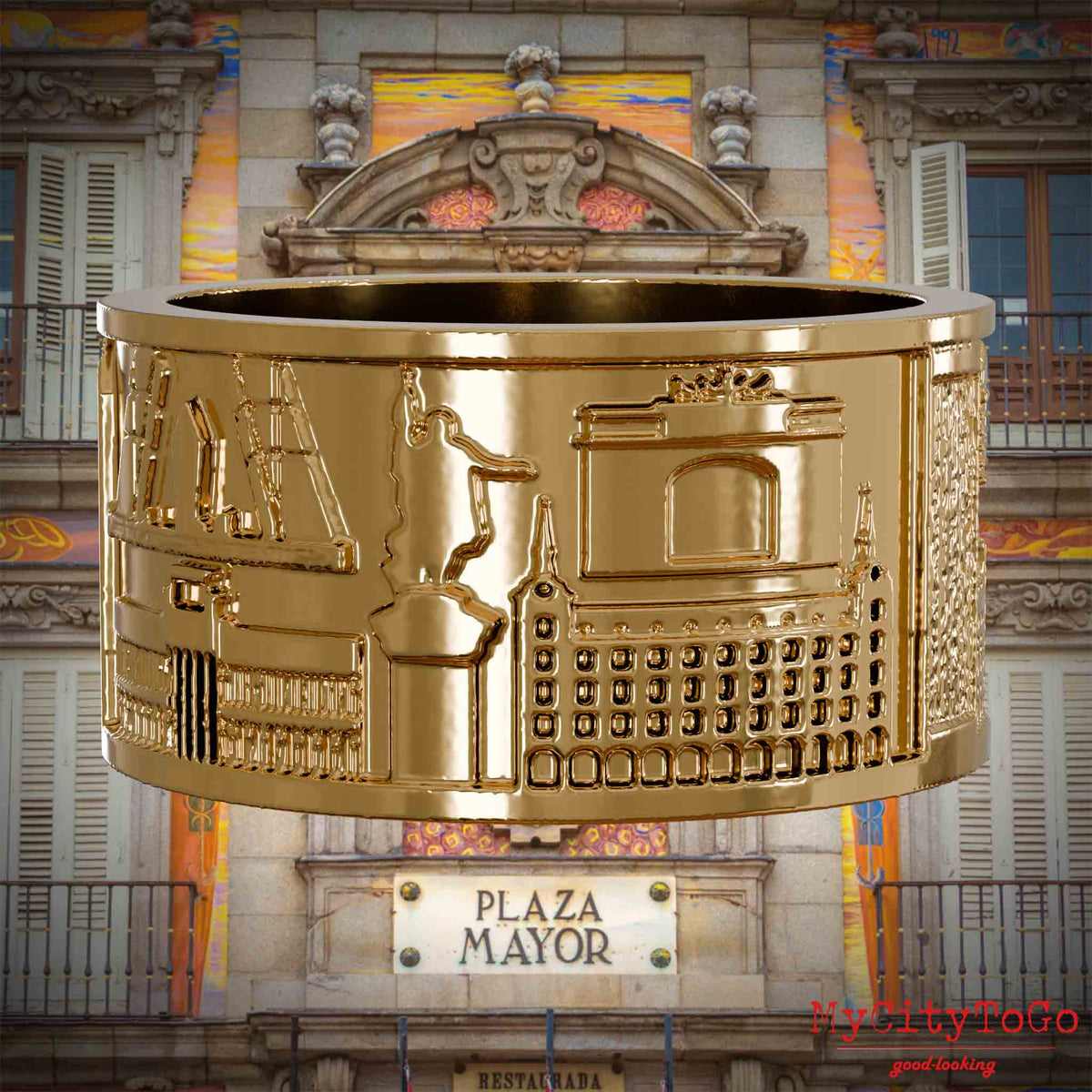 Vergoldeter Ring mit Reliefs bekannter Sehenswürdigkeiten der Stadt Madrid. Den Hintergrund bildet eine Ansicht der Stadt Madrid.