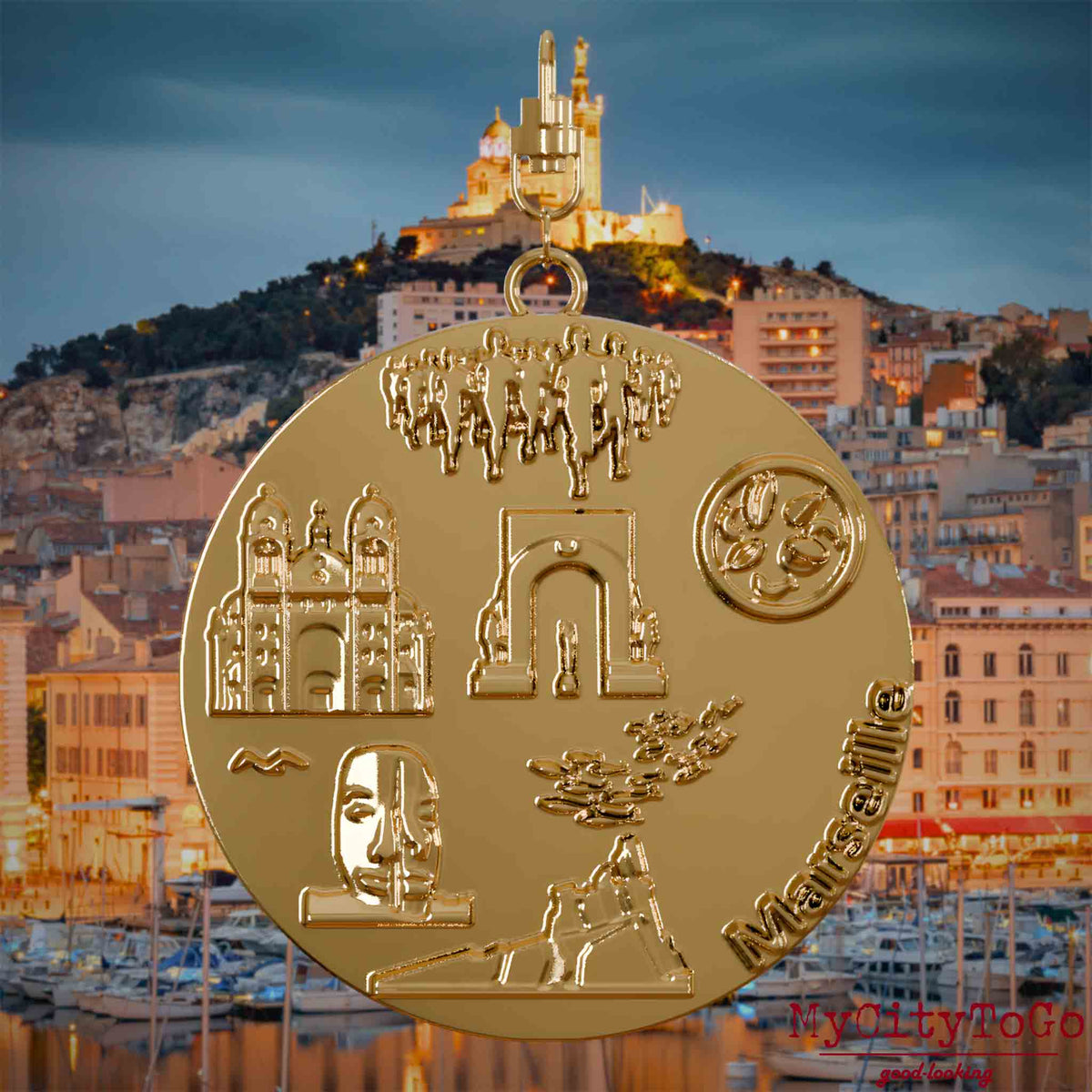 Halskette mit Drehwirbel und Rückseite eines vergoldeten Schmuckanhängers, auf dem Reliefs bekannter Sehenswürdigkeiten der Stadt Marseille abgebildet sind. Den Hintergrund bildet eine Ansicht der Stadt Marseille.
