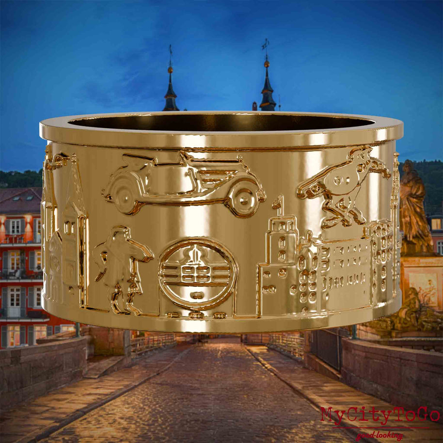 Vergoldeter Ring mit Reliefs bekannter Sehenswürdigkeiten der Stadt Heidelberg. Den Hintergrund bildet eine Ansicht der Stadt Heidelberg.