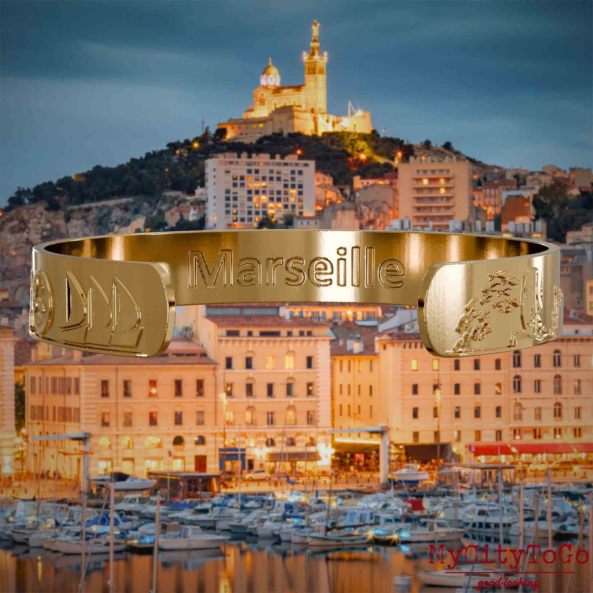 Innenseite eines vergoldeten Armreifs mit Reliefs bekannter Sehenswürdigkeiten der Stadt Marseille 
und einer Gravur des Stadtnamens. Den Hintergrund bildet eine Ansicht der Stadt Marseille.