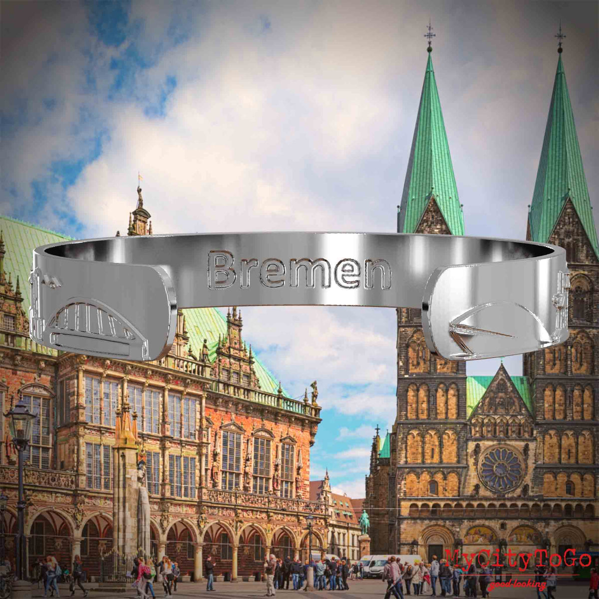 Innenseite eines silbernen Armreifs mit Reliefs bekannter Sehenswürdigkeiten der Stadt Bremen und einer Gravur des Stadtnamens. Den Hintergrund bildet eine Ansicht der Stadt Bremen.