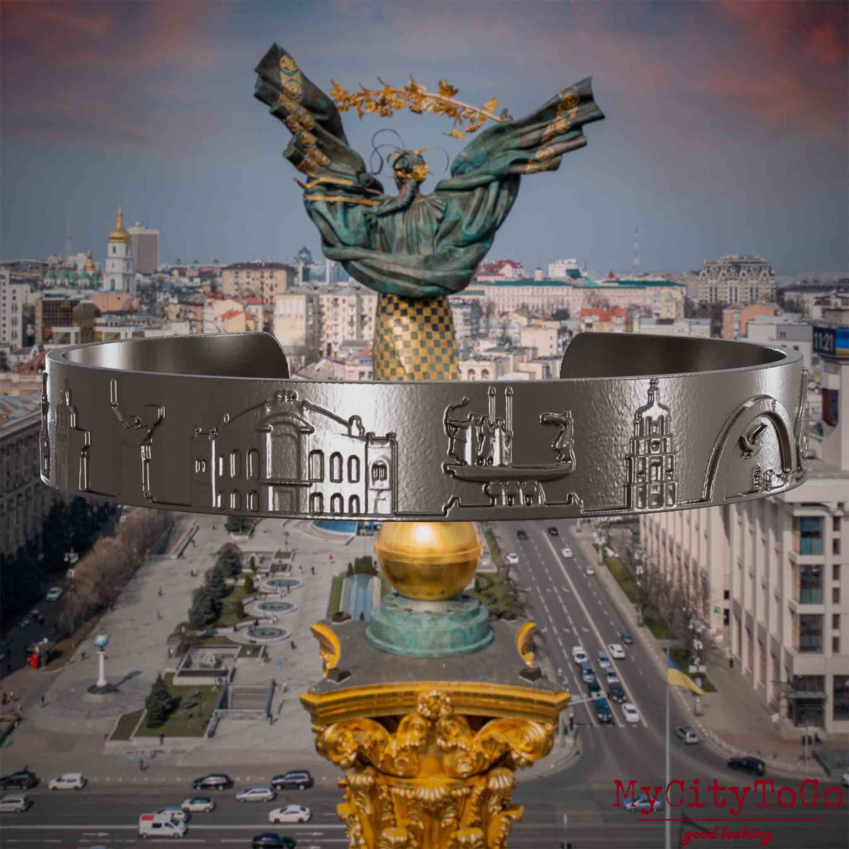 Armreif aus Titan mit Reliefs bekannter Sehenswürdigkeiten der Stadt Kiew. Den Hintergrund bildet eine Ansicht der Stadt Kiew.