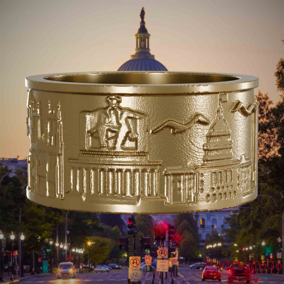 Ring aus vergoldetem Edelstahl mit Reliefs bekannter Sehenswürdigkeiten der Stadt Washington. Den Hintergrund bildet eine Ansicht der Stadt Washington.