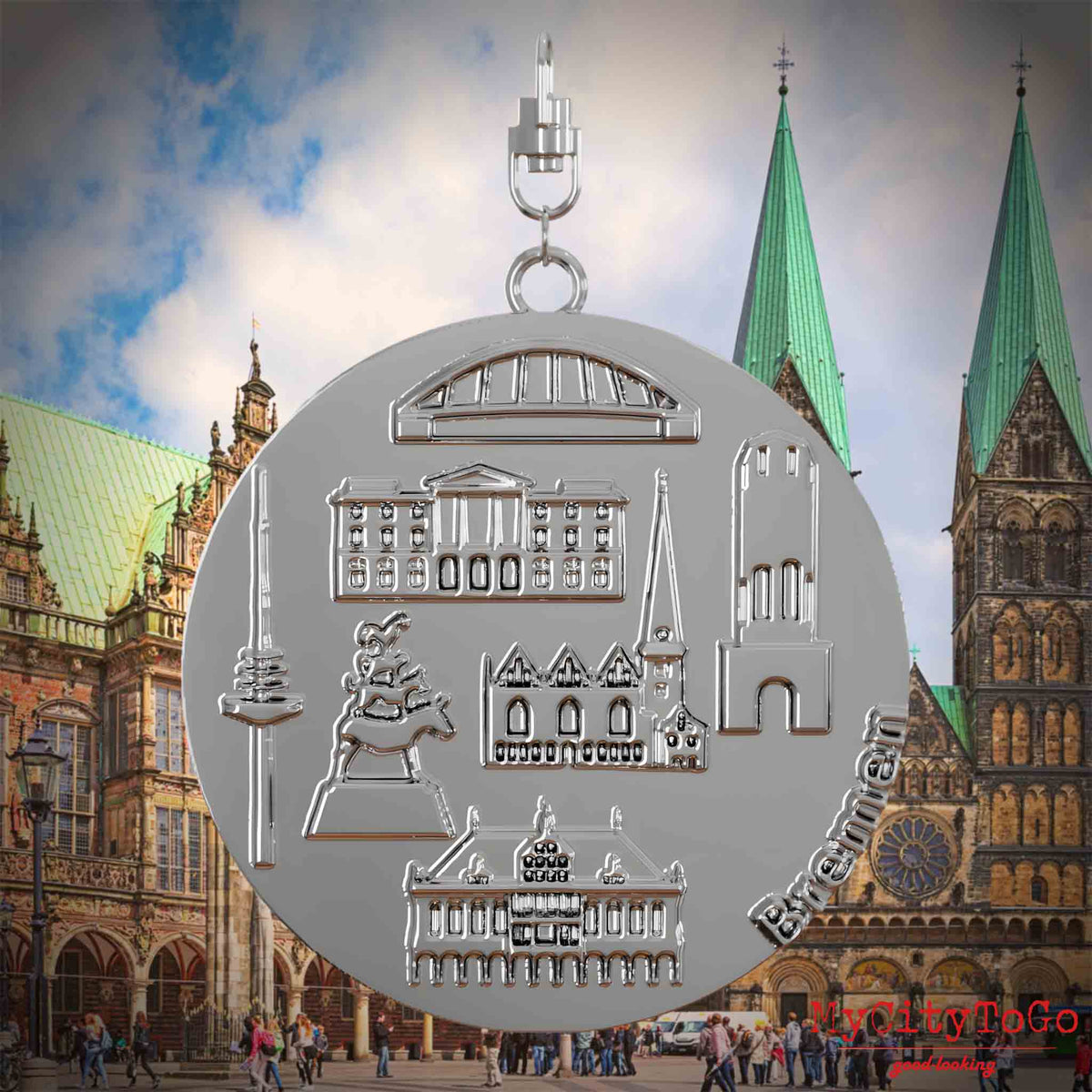 Halskette mit Drehwirbel und Vorderseite eines silbernen Schmuckanhängers, auf dem Reliefs bekannter Sehenswürdigkeiten der Stadt Bremen abgebildet sind. Den Hintergrund bildet eine Ansicht der Stadt Bremen.