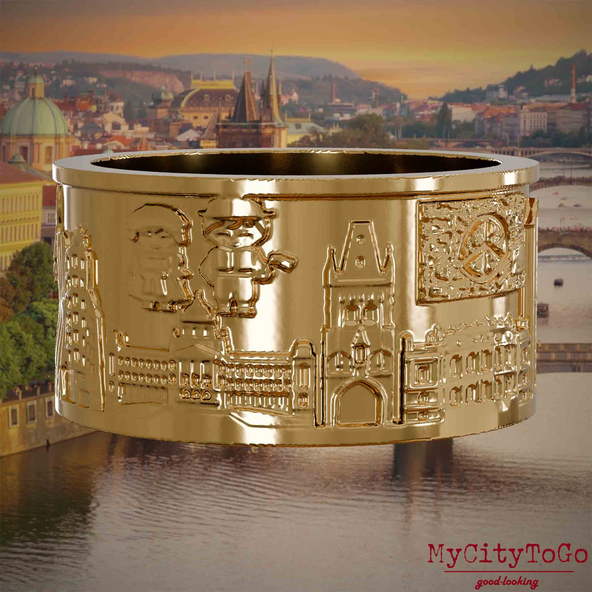 Vergoldeter Ring mit Reliefs bekannter Sehenswürdigkeiten der Stadt Prag. Den Hintergrund bildet eine Ansicht der Stadt Prag.