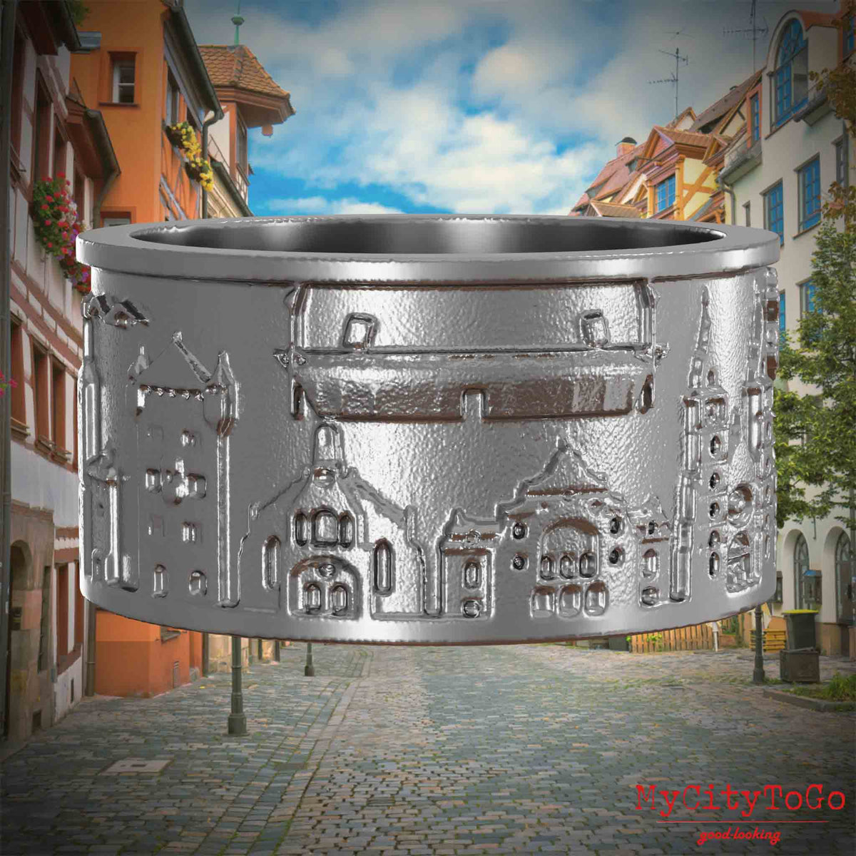 Ring aus Edelstahl mit Reliefs bekannter Sehenswürdigkeiten der Stadt Nuernberg. Den Hintergrund bildet eine Ansicht der Stadt  Nuernberg.