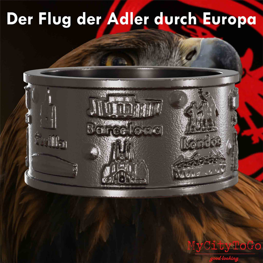 Ring aus Titan mit Reliefs bekannter Sehenswürdigkeiten der Spielorte und Stadien der Frankfurter Europa-League-Saison 2021/22 mit einem Adlerkopf als Hintergrund