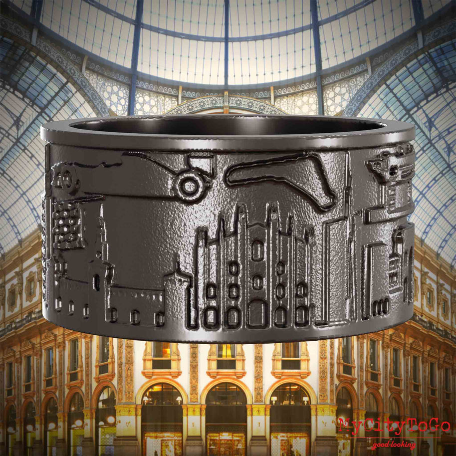 Ring aus Titan mit Reliefs bekannter Sehenswürdigkeiten der Stadt Mailand. Den Hintergrund bildet eine Ansicht der Stadt Mailand.