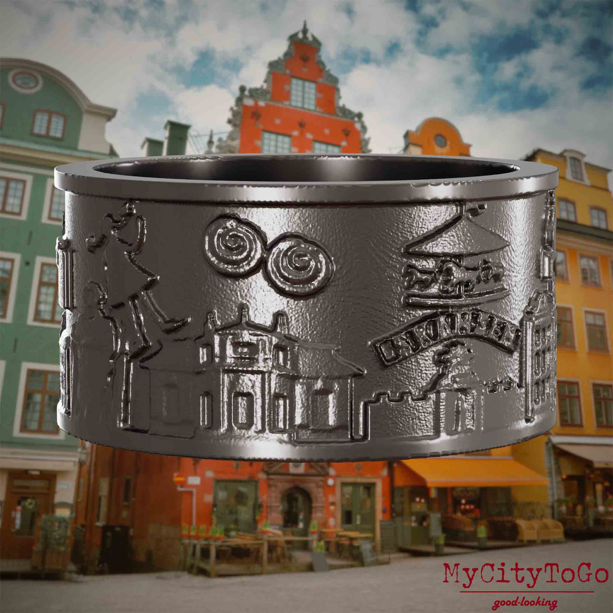 Ring aus Titan mit Reliefs bekannter Sehenswürdigkeiten der Stadt Stockholm. Den Hintergrund bildet eine Ansicht der Stadt Stockholm.