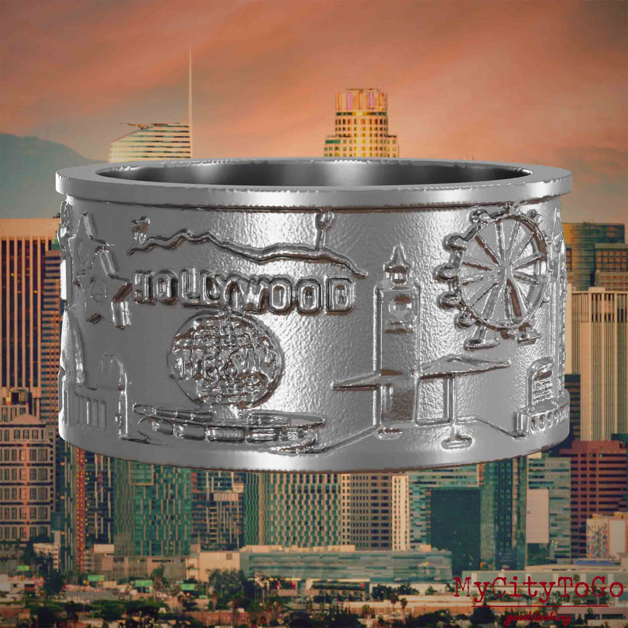 Ring aus Edelstahl mit Reliefs bekannter Sehenswürdigkeiten der Stadt Los Angeles. Den Hintergrund bildet eine Ansicht der Stadt Los Angeles.