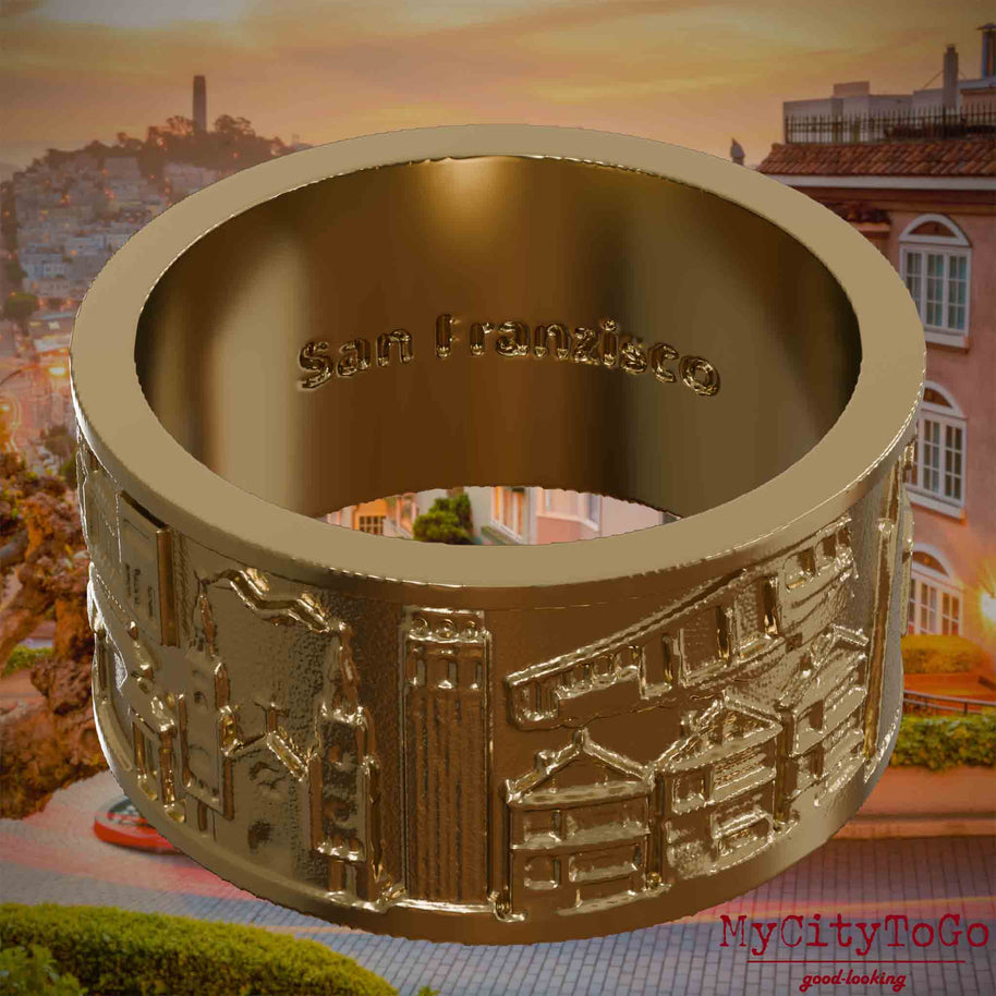 Ring aus vergoldetem Edelstahl mit Reliefs bekannter Sehenswürdigkeiten der Stadt San Francisco und einer Gravur des Stadtnamens auf der Innenseite. Den Hintergrund bildet eine Ansicht der Stadt San Francisco.