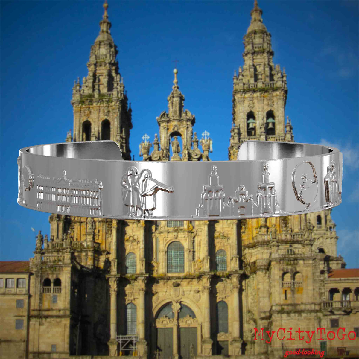 Versilberter Armreif mit Reliefs bekannter Sehenswürdigkeiten und Elemente des Jakobsweges. Den Hintergrund bildet die Kathedrale von Santiago de Compostela.