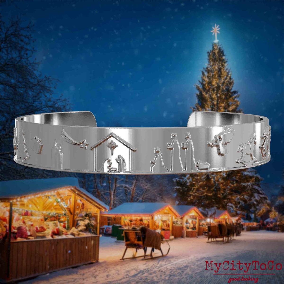 Silberner Armreif mit Reliefs weihnachtlicher Motive. Den Hintergrund bildet ein naechtliches Weihnachtsmotiv.