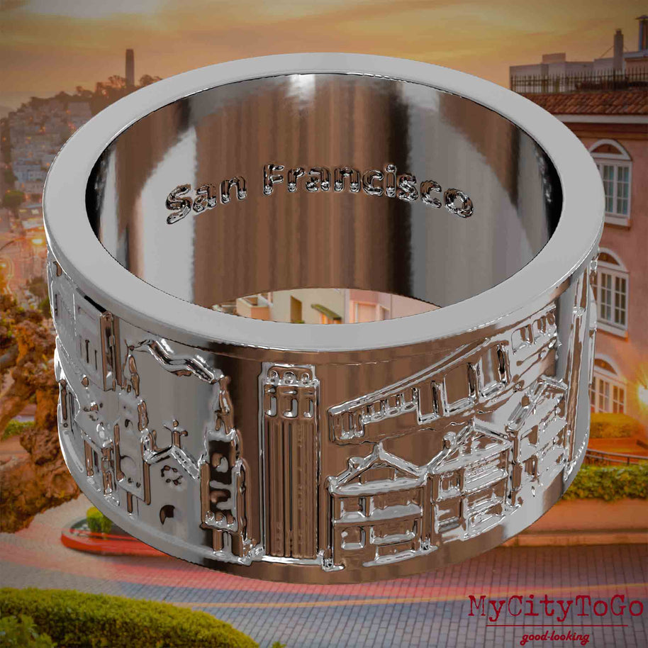 Versilberter Ring mit Reliefs bekannter Sehenswürdigkeiten der Stadt San Francisco und einer Gravur des Stadtnamens auf der Innenseite. Den Hintergrund bildet eine Ansicht der Stadt San Francisco.