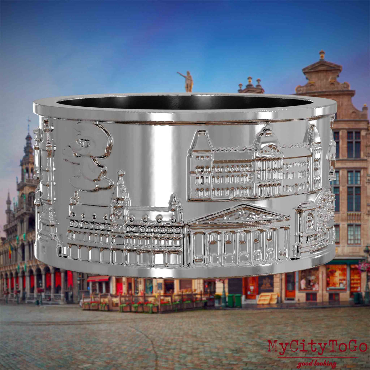 Silberner Ring mit Reliefs bekannter Sehenswürdigkeiten der Stadt Bruessel. Den Hintergrund bildet eine Ansicht der Stadt Bruessel.