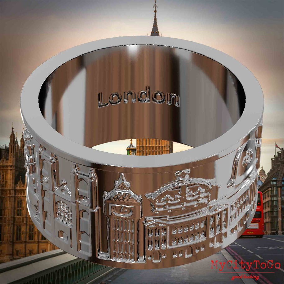 Versilberter Ring mit Reliefs bekannter Sehenswürdigkeiten der Stadt London und einer Gravur des Stadtnamens auf der Innenseite. Den Hintergrund bildet eine Ansicht der Stadt London.