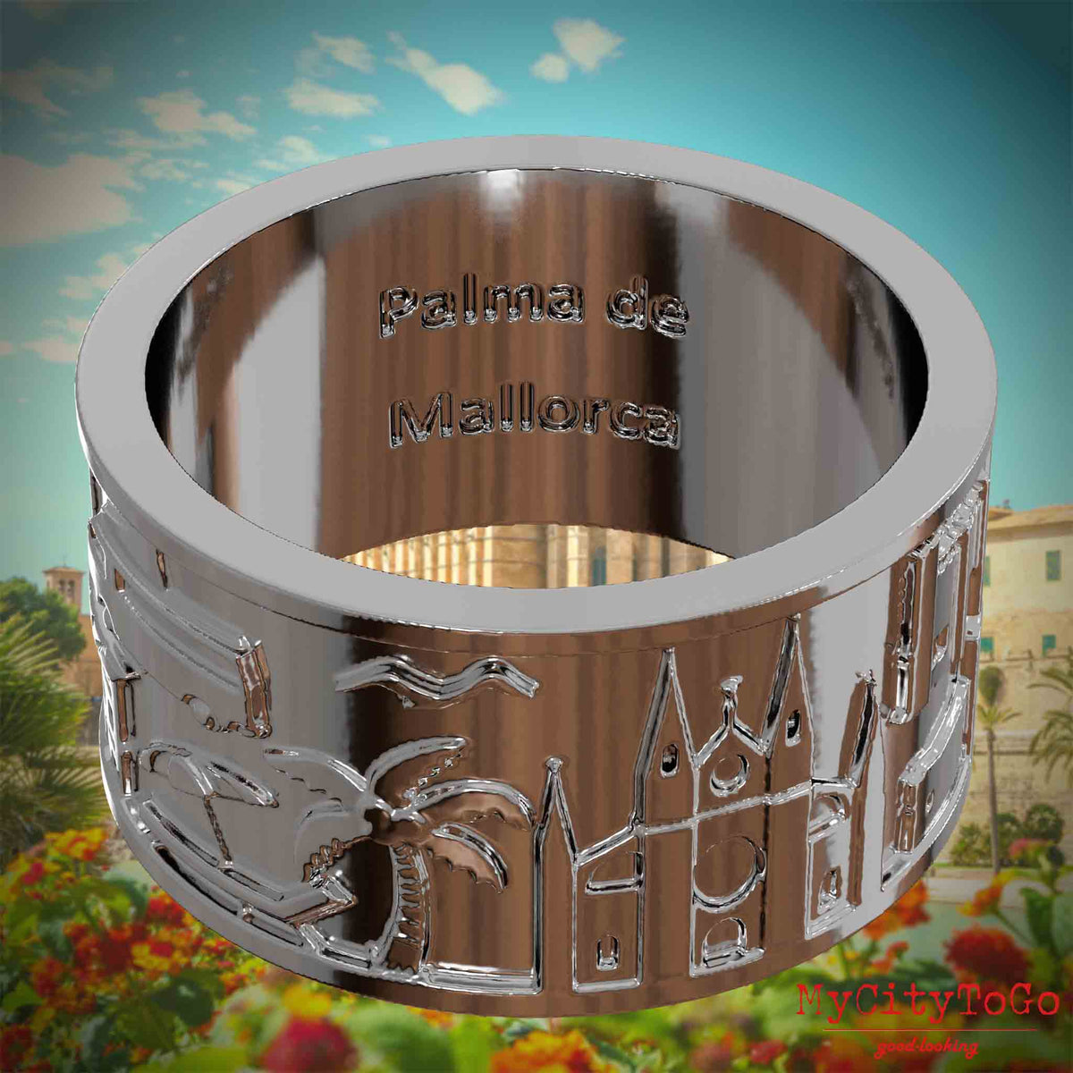 Versilberter Ring mit Reliefs bekannter Sehenswürdigkeiten der Stadt Palma de Mallorca und einer Gravur des Stadtnamens auf der Innenseite. Den Hintergrund bildet eine Ansicht der Stadt Palma de Mallorca.