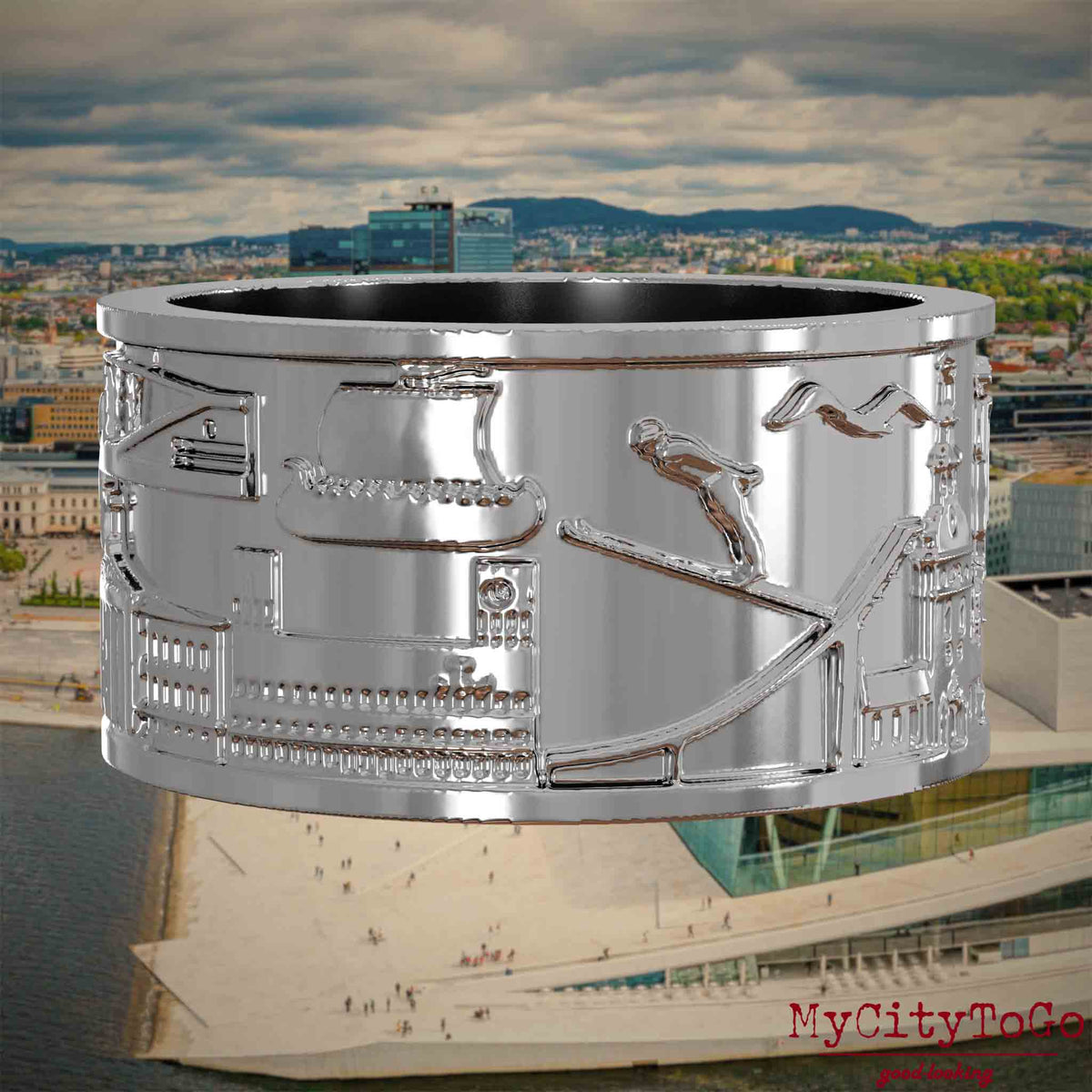 Silberner Ring mit Reliefs bekannter Sehenswürdigkeiten der Stadt Oslo. Den Hintergrund bildet eine Ansicht der Stadt Oslo.