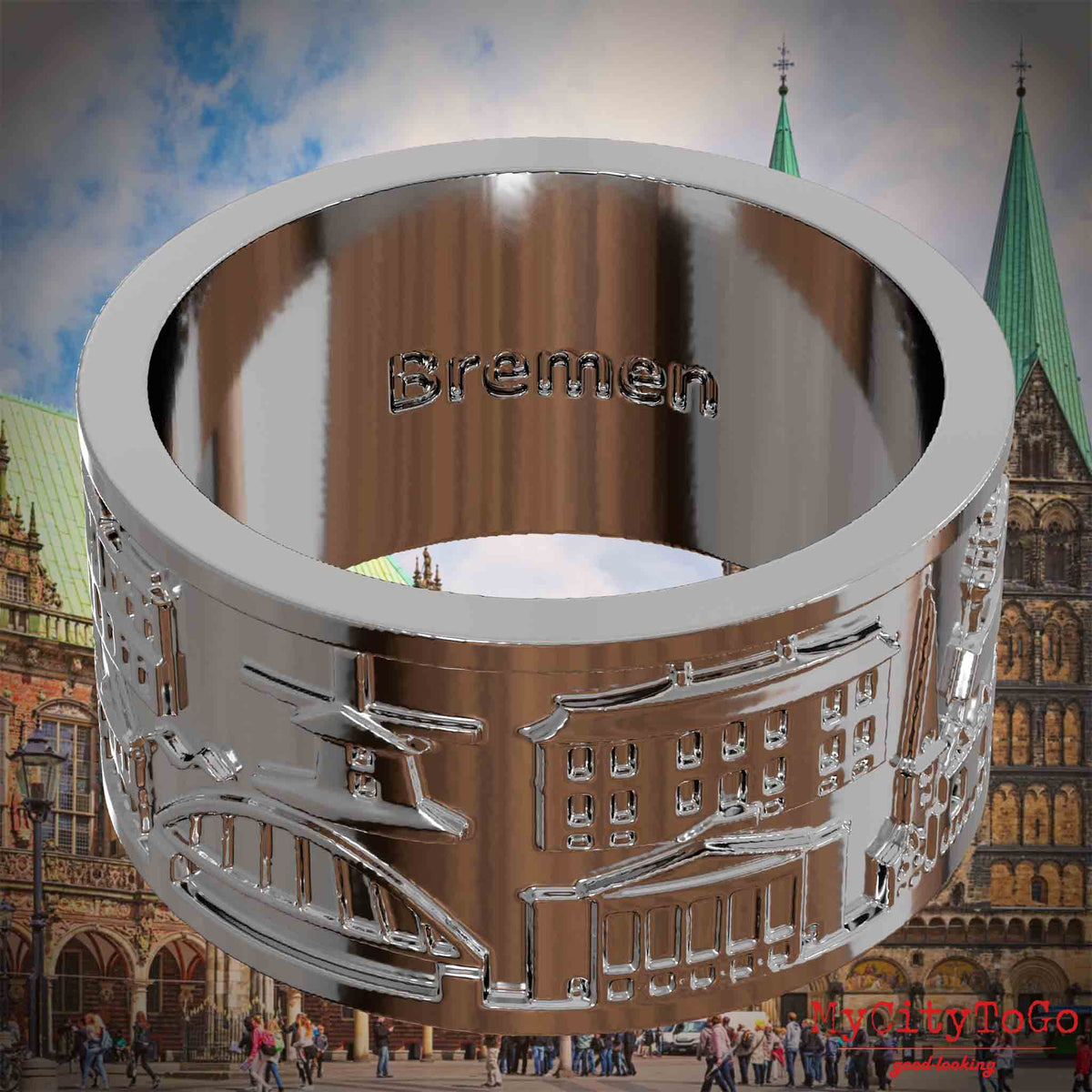 Versilberter Ring mit Reliefs bekannter Sehenswürdigkeiten der Stadt Bremen und einer Gravur des Stadtnamens auf der Innenseite. Den Hintergrund bildet eine Ansicht der Stadt Bremen.