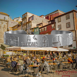 Armreif aus Edelstahl mit Reliefs bekannter Sehenswürdigkeiten der Stadt Porto. Den Hintergrund bildet eine Ansicht der Stadt Porto.