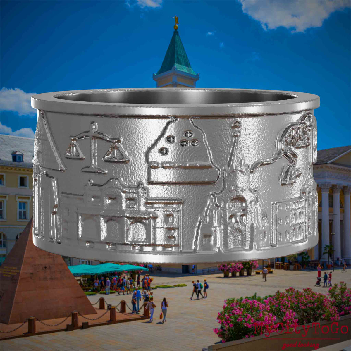 Ring aus Edelstahl mit Reliefs verschiedener Motive der Stadt Karlsruhe.. Den Hintergrund bildet eine Ansicht der Stadt Karlsruhe.