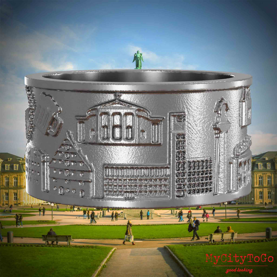 Ring aus Edelstahl mit Reliefs bekannter Sehenswürdigkeiten der Stadt Stuttgart. Den Hintergrund bildet eine Ansicht der Stadt Stuttgart.