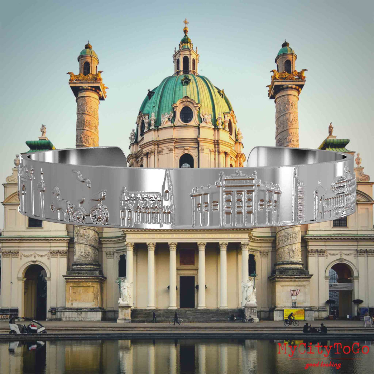 Versilberter Armreif mit Reliefs bekannter Sehenswürdigkeiten der Stadt Wien. Den Hintergrund bildet eine Ansicht der Stadt Wien.