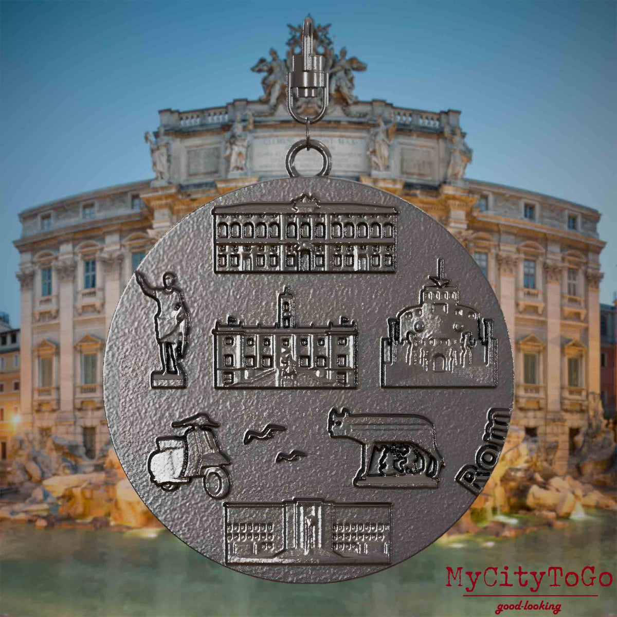 Halskette mit Drehwirbel und Vorderseite eines Schmuckanhängers aus Titan, auf dem Reliefs bekannter Sehenswürdigkeiten der Stadt Rom abgebildet sind. Den Hintergrund bildet eine Ansicht der Stadt Rom.
