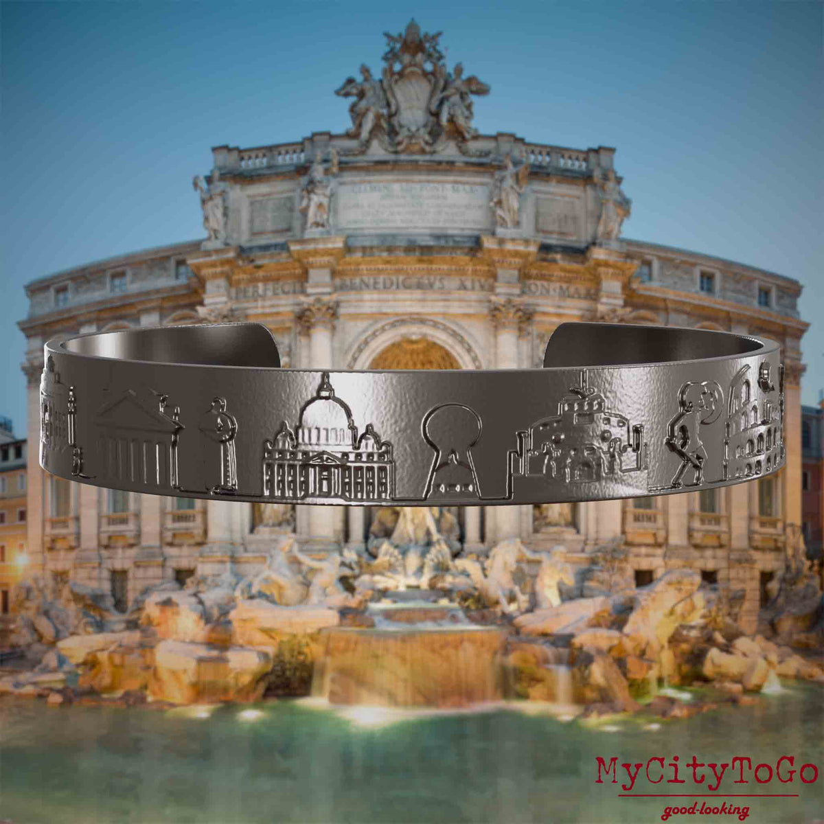 Armreif aus Titan mit Reliefs bekannter Sehenswürdigkeiten der Stadt Rom. Den Hintergrund bildet eine Ansicht der Stadt Rom.