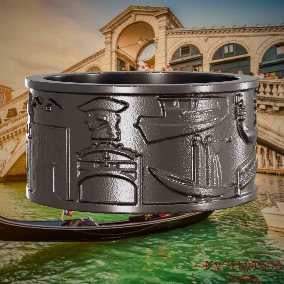 Ring aus Titan mit Reliefs bekannter Sehenswürdigkeiten der Stadt Venedig. Den Hintergrund bildet eine Ansicht der Stadt Venedig.