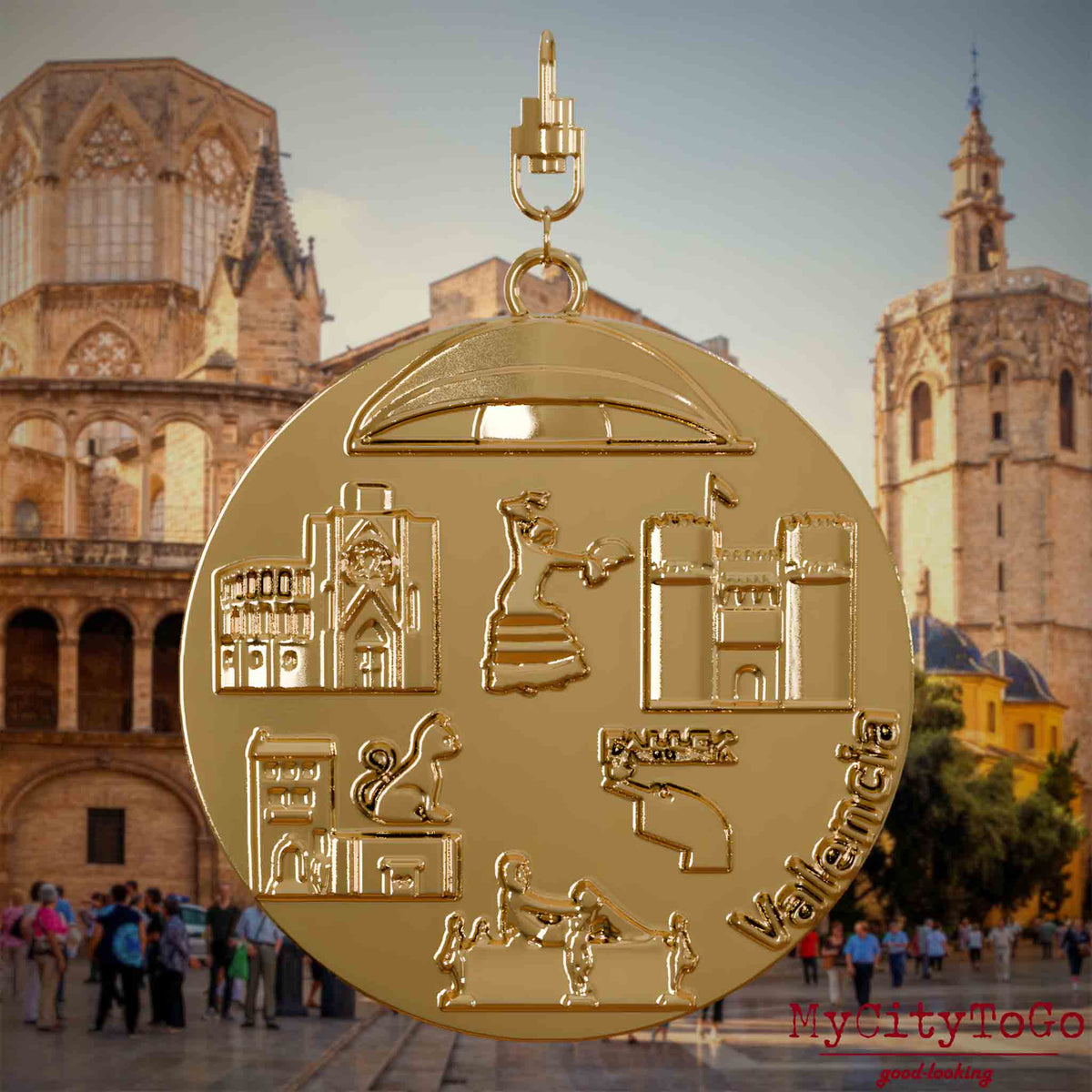 Halskette mit Drehwirbel und Rückseite eines vergoldeten Schmuckanhängers, auf dem Reliefs bekannter Sehenswürdigkeiten der Stadt Valencia abgebildet sind. Den Hintergrund bildet eine Ansicht der Stadt Valencia.
