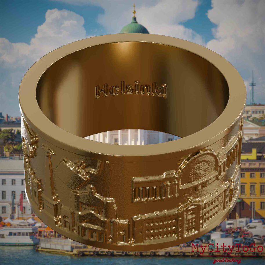 Vergoldeter Ring aus Edelstahl mit Reliefs bekannter Sehenswürdigkeiten der Stadt Helsinki und einer Gravur des Stadtnamens auf der Innenseite. Den Hintergrund bildet eine Ansicht der Stadt Helsinki.