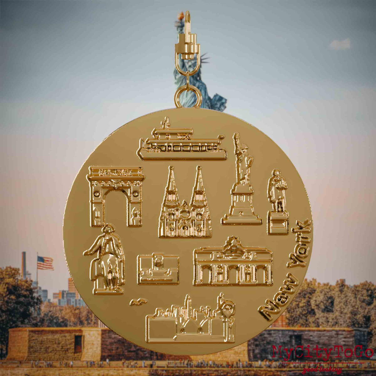 Halskette mit Drehwirbel und Vorderseite eines vergoldeten Schmuckanhängers, auf dem Reliefs bekannter Sehenswürdigkeiten der Stadt New York abgebildet sind. Den Hintergrund bildet eine Ansicht der Stadt New York.
