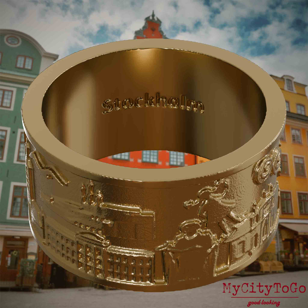 Ring aus vergoldetem Edelstahl mit Reliefs bekannter Sehenswürdigkeiten der Stadt Stockholm und einer Gravur des Stadtnamens auf der Innenseite. Den Hintergrund bildet eine Ansicht der Stadt Stockholm.