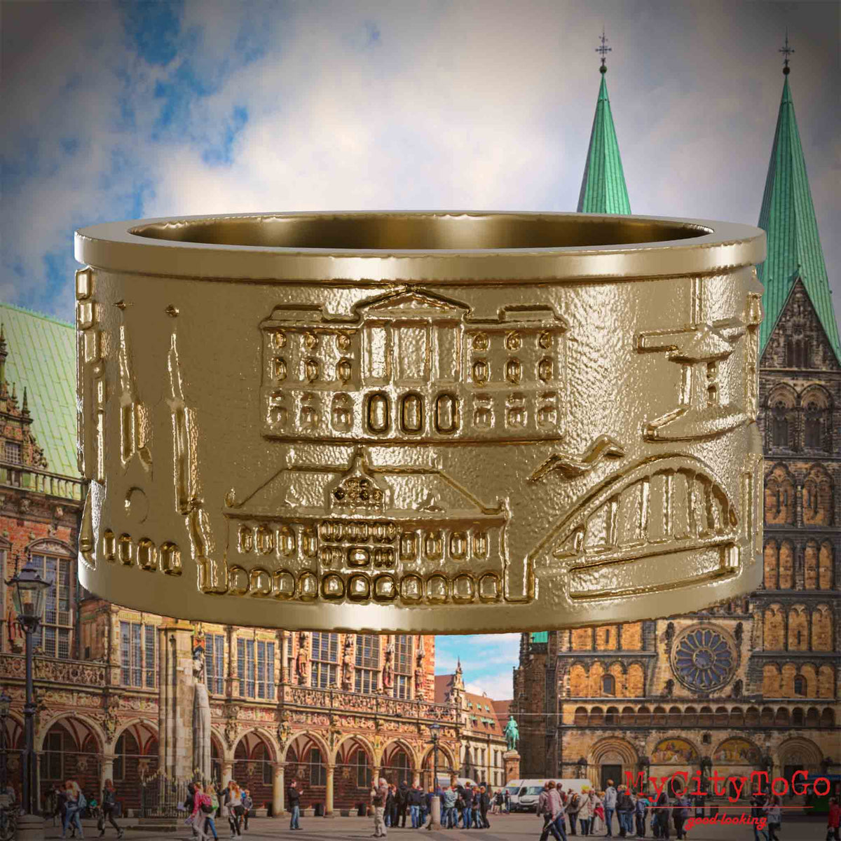 Ring aus vergoldetem Edelstahl mit Reliefs bekannter Sehenswürdigkeiten der Stadt Bremen. Den Hintergrund bildet eine Ansicht der Stadt Bremen.