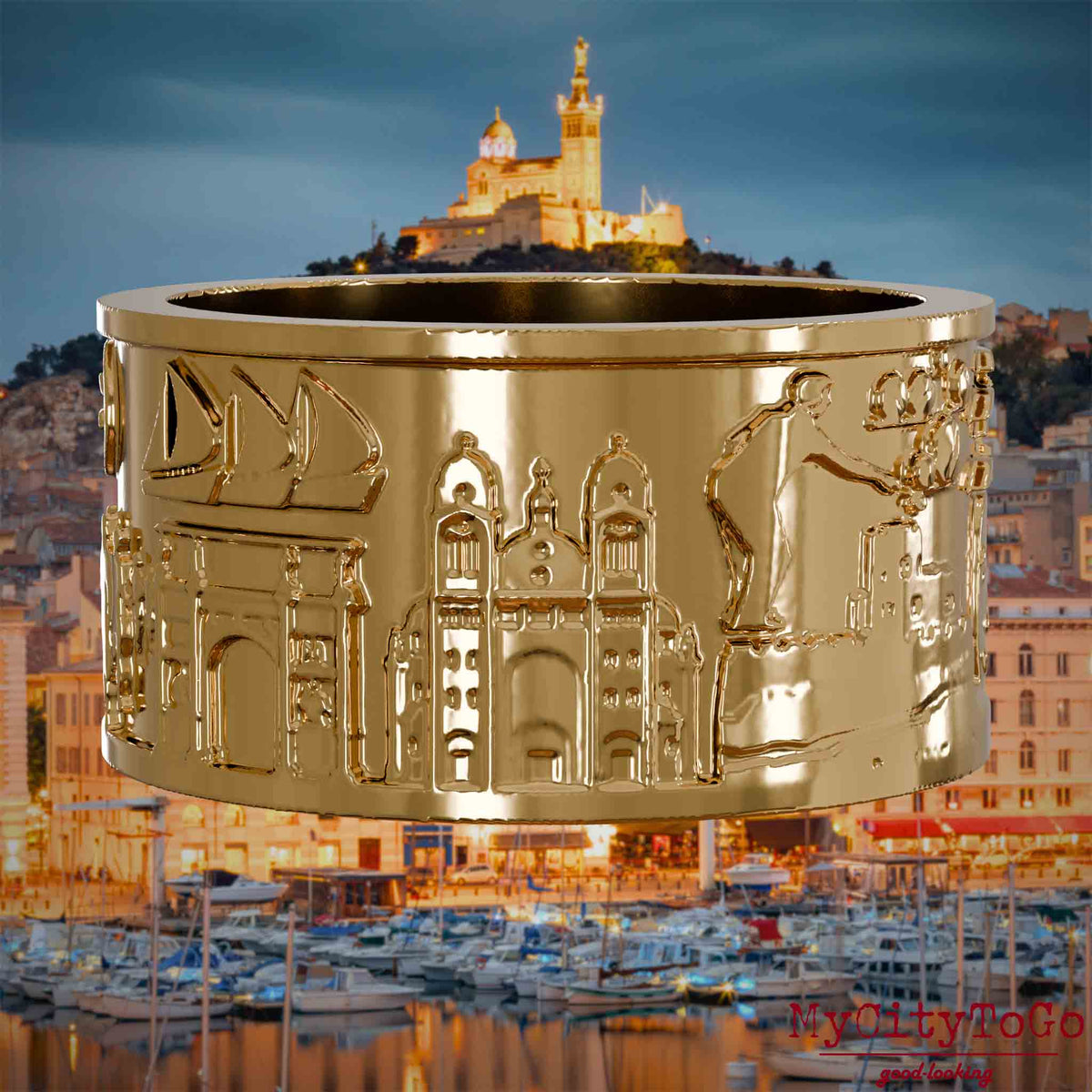 Vergoldeter Ring mit Reliefs bekannter Sehenswürdigkeiten der Stadt Marseille. Den Hintergrund bildet eine Ansicht der Stadt Marseille.