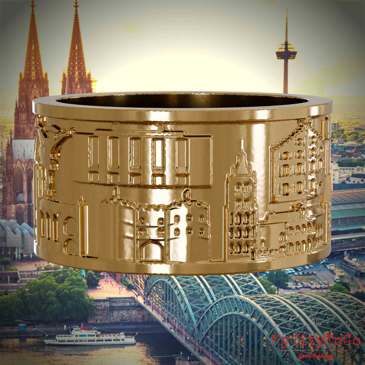 Vergoldeter Ring mit Reliefs bekannter Sehenswürdigkeiten der Stadt Koeln. Den Hintergrund bildet eine Ansicht der Stadt Koeln.