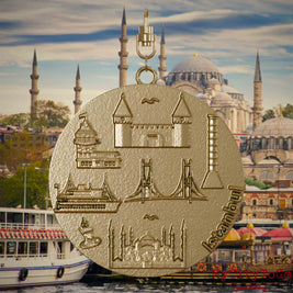 Halskette mit Drehwirbel und Vorderseite eines Schmuckanhängers aus vergoldetem Edelstahl, auf dem Reliefs bekannter Sehenswürdigkeiten der Stadt Istanbul abgebildet sind. Den Hintergrund bildet eine Ansicht der Stadt Istanbul.
