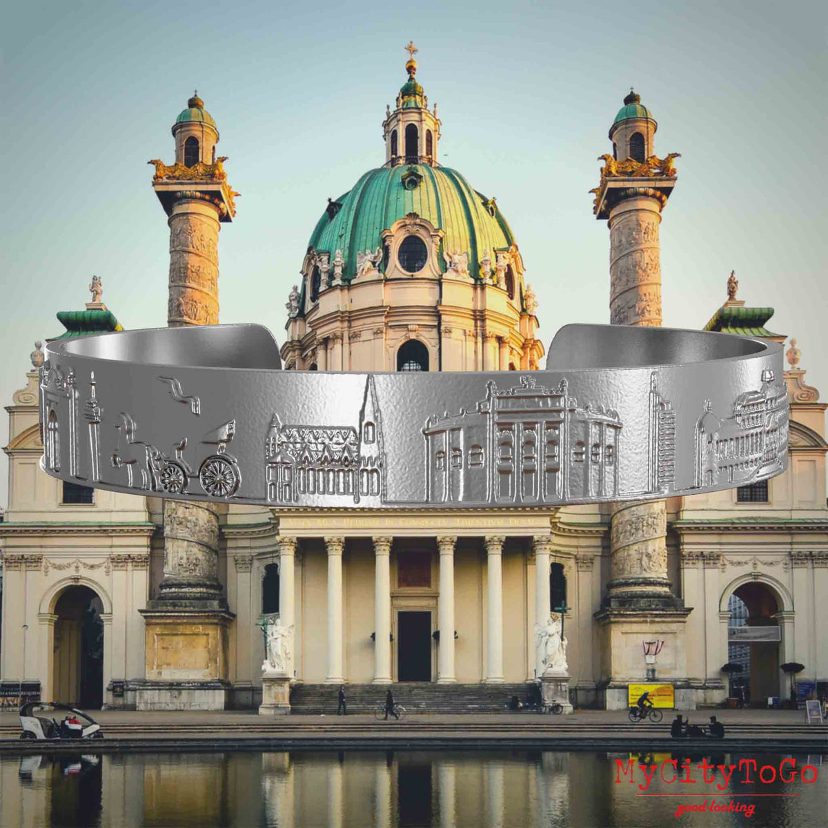 Armreif aus Edelstahl mit Reliefs bekannter Sehenswürdigkeiten der Stadt Wien. Den Hintergrund bildet eine Ansicht der Stadt Wien.